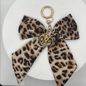 914. Leopard Print Bow Keychain with LV Gold Charm Accent